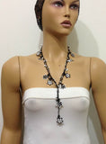 10.16.12 Black and White beaded flower lariat necklace with white beads.