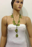 10.20.23 GREEN OYA Flower Lariat Necklace with purplish black beads.